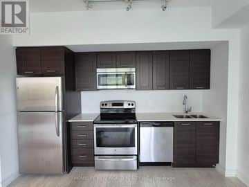 Toronto (Mimico) condo for rent - A kitchen with dark brown cabinets and stainless steel appliances.