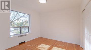 Toronto (Yonge-Eglinton) condo for rent - A room with a window and wooden flooring is for sale.