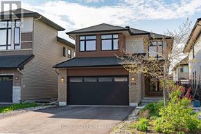 Ottawa apartment for rent - A modern house with a black garage door is for sale.