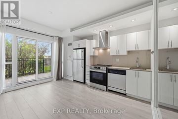 Toronto (Mimico) condo for rent - A modern kitchen with white cabinets and stainless steel appliances.