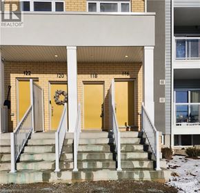 Kitchener condo for rent - The front of a building with the number 122 on it.