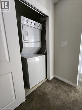 Kitchener condo for rent - A white oven and dishwasher are built into a wall.