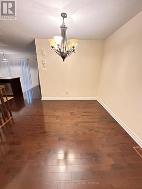 Ottawa apartment for rent - A room with wooden flooring and a chandelier hanging from the ceiling.