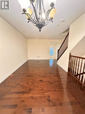 Ottawa apartment for rent - A long hallway with wood floors and a chandelier.