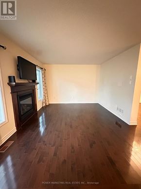 Ottawa apartment for rent - A living room with wood floors and a fireplace.