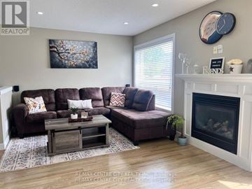 London North (North I) apartment for rent - A living room with a brown couch and a fireplace.