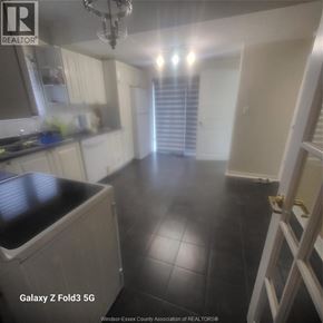 Windsor apartment for rent - A kitchen with black tile flooring and white walls.