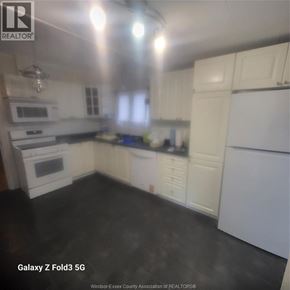 Windsor apartment for rent - A kitchen with white cabinets and appliances.