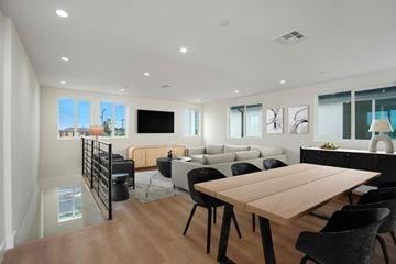 Los Angeles apartment for rent - A modern living room with a wooden dining table and black chairs.