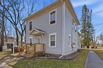 St. Johns apartment for rent - A house with a grey siding and a brown wooden deck.