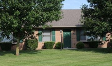 Springfield apartment for rent - A house with a green door and a tree in front.
