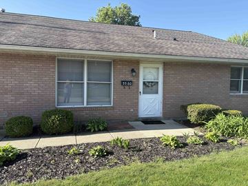 Springfield apartment for rent - A house with a white door and windows with bushes in front.
