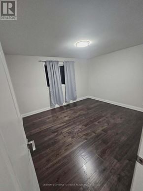 Toronto (Glenfield-Jane Heights) apartment for rent - A room with wooden flooring and a window with curtains.