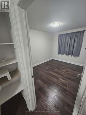 Toronto (Glenfield-Jane Heights) apartment for rent - A room with wooden floors and a window with curtains.