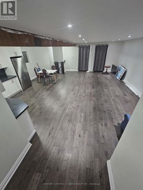 Toronto (Glenfield-Jane Heights) apartment for rent - A realtor photo of a room with wood flooring and a kitchenette.