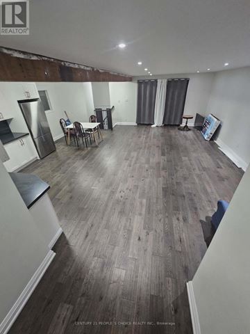 Toronto (Glenfield-Jane Heights) apartment for rent - A realtor photo of a room with wood flooring and a kitchenette.