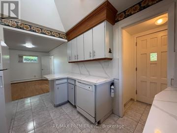 St. Catharines (Fairview) apartment for rent - A kitchen with white cabinets and a wooden counter top.