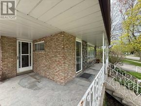 St. Catharines (Fairview) apartment for rent - A house with a white fence and a brick wall.