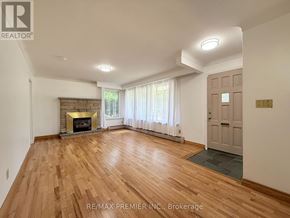 St. Catharines (Fairview) apartment for rent - A spacious room with a fireplace and wooden flooring.