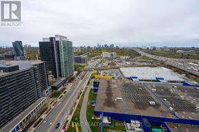 Toronto (Bayview Village) condo for rent - A parking lot with a few cars and a building in the background.