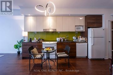Toronto (Bayview Village) condo for rent - A modern kitchen with a dining table set for two.