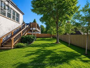 Toronto (Forest Hill South) apartment for rent - A backyard with a wooden deck and a green lawn.