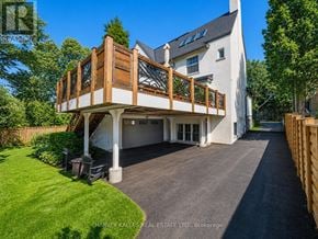 Toronto (Forest Hill South) apartment for rent - A large white house with a wooden deck and a driveway.