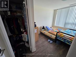 Markham (Unionville) condo for rent - A bedroom with a bed, a wardrobe, and a window with blinds.