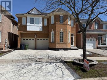 Toronto (Rouge) apartment for rent - A large brick house with a tree in front and a sign that says REALTOR.