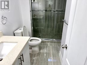 Toronto (Rouge) apartment for rent - A bathroom with a toilet, sink, and shower.