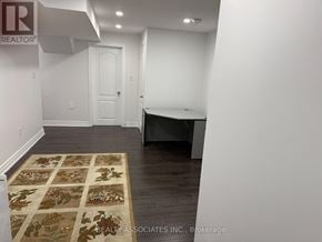 Toronto (Rouge) apartment for rent - A room with a rug on the floor and a door in the background.