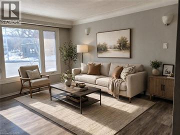 Hamilton apartment for rent - A living room with a couch, chair, and a painting on the wall.