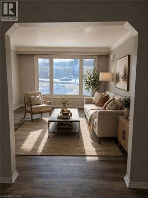 Hamilton apartment for rent - A well-lit living room with a large window, a sofa, a chair, and a coffee table.