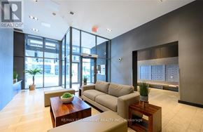 Burlington (Uptown) condo for rent - A modern office lobby with a reception desk and a large window.