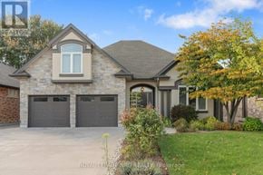 St. Catharines (Lakeshore) apartment for rent - A house with a brown garage door is for sale.
