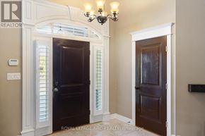 St. Catharines (Lakeshore) apartment for rent - A room with a chandelier, two doors, and a wall-mounted sign that says "REALTOR".
