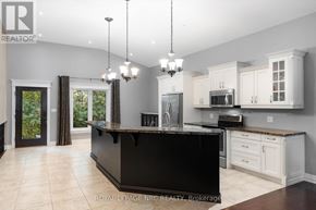 St. Catharines (Lakeshore) apartment for rent - A modern kitchen with a black island and white cabinets.