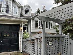Collingwood apartment for rent - A house with a black door and a grey fence with a sign that says "FOUR".