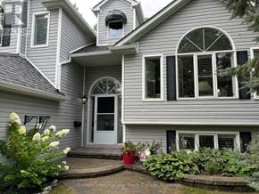 Collingwood apartment for rent - A house with a grey siding and a white door is for sale.
