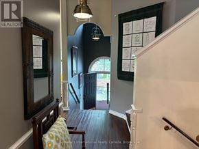 Collingwood apartment for rent - A hallway with a wooden floor and a staircase.