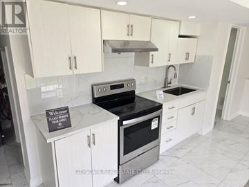 Brampton (Credit Valley) apartment for rent - A kitchen with a sign on the counter that says "Please remove your shoes".