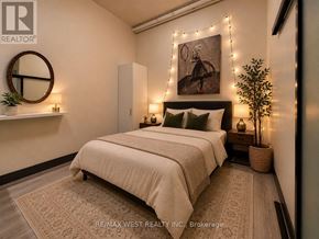 Hamilton (Beasley) condo for rent - A bedroom with a bed, a mirror, and a painting on the wall.