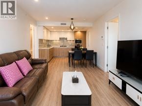 Richmond apartment for rent - A living room with a brown leather couch and a white coffee table.