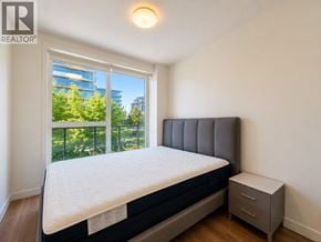 Richmond apartment for rent - A bedroom with a bed, nightstand, and window overlooking a balcony.