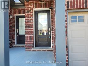 Thorold (Confederation Heights) townhouse for rent - A house with a black door and a white garage door.