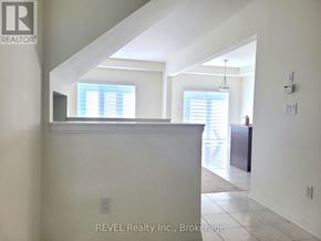 Thorold (Confederation Heights) townhouse for rent - A white interior of a house with a window and a door.