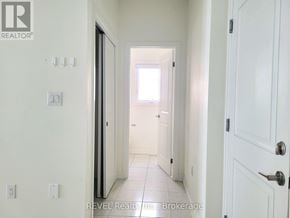 Thorold (Confederation Heights) townhouse for rent - A hallway with white walls and a white door.