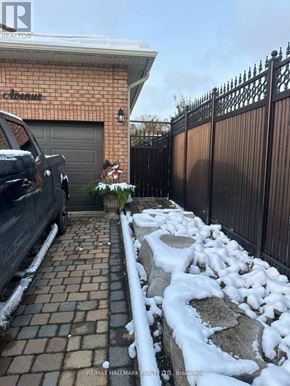 Toronto (Rustic) apartment for rent - A black truck is parked in front of a house with a sign that says "RE/MAX Hallmark Realty, Brockton.".