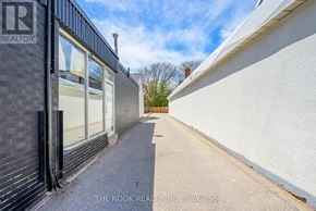 Oshawa (Centennial) condo for rent - A narrow alley with a sign that reads "REALTOR" on the left side.