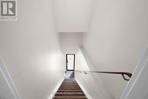 Oshawa (Centennial) condo for rent - A stairway leading to a door at the end.